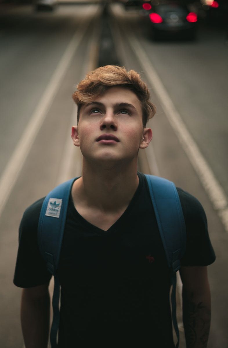 man standing in the middle of road