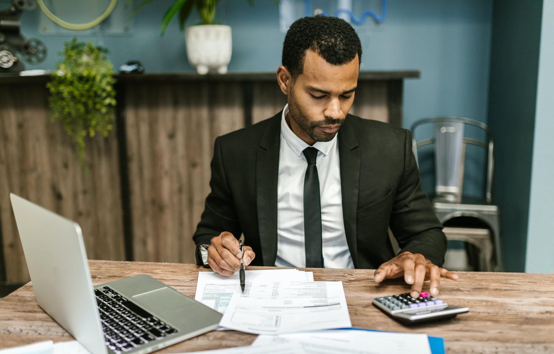 man in black suit working