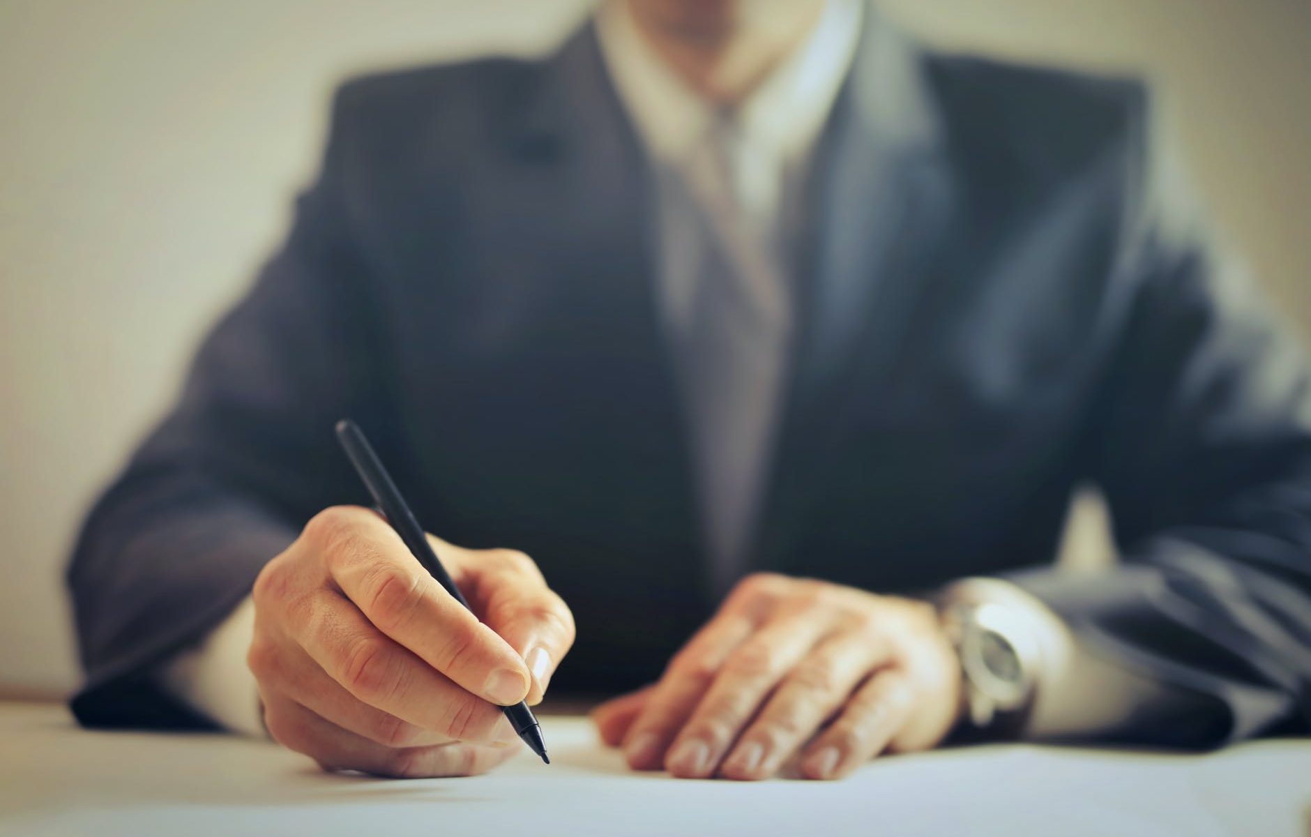 crop businessman signing contract in office