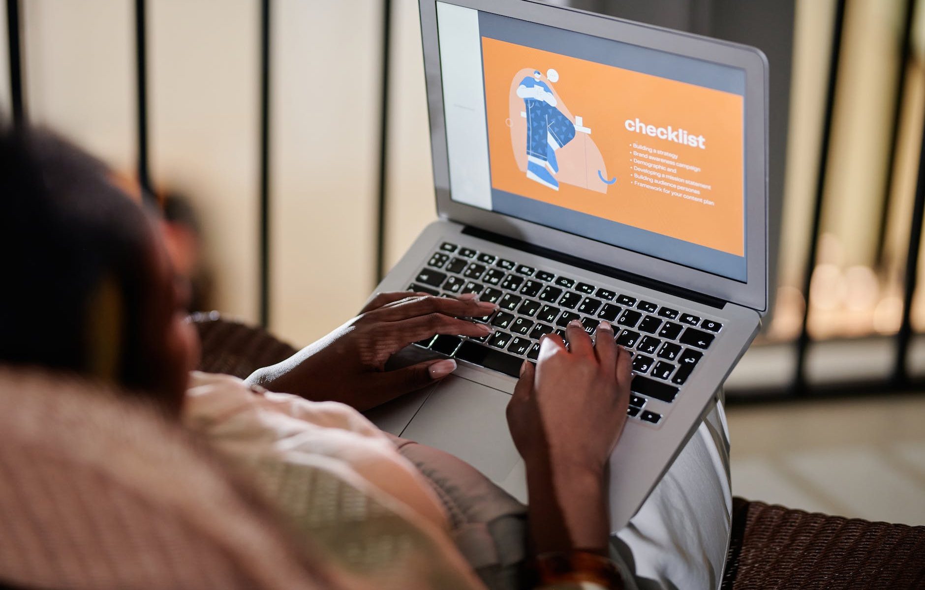 person sitting on sofa using laptop