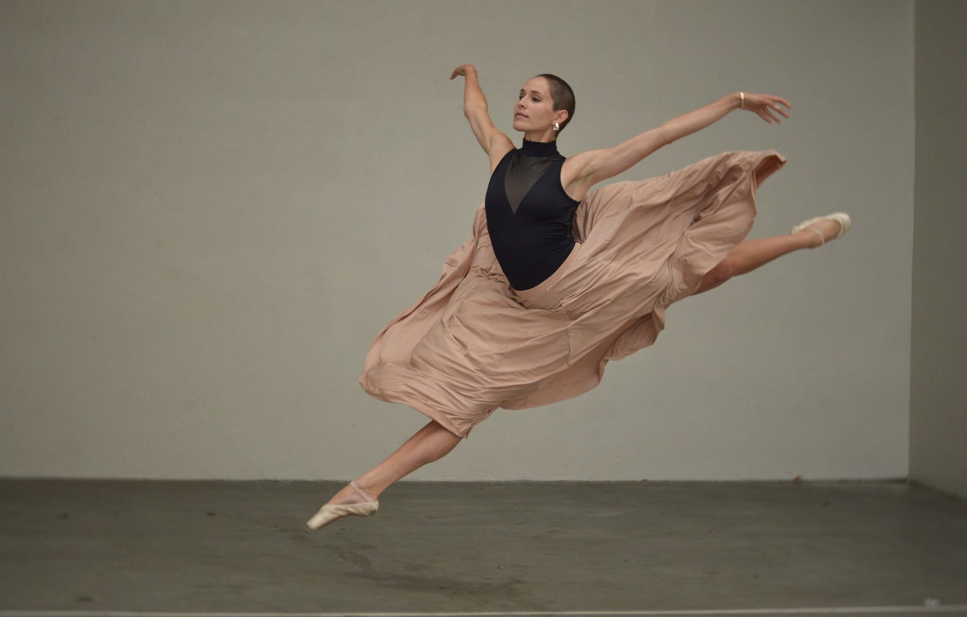 muscular female dancer rehearsing in spacious studio