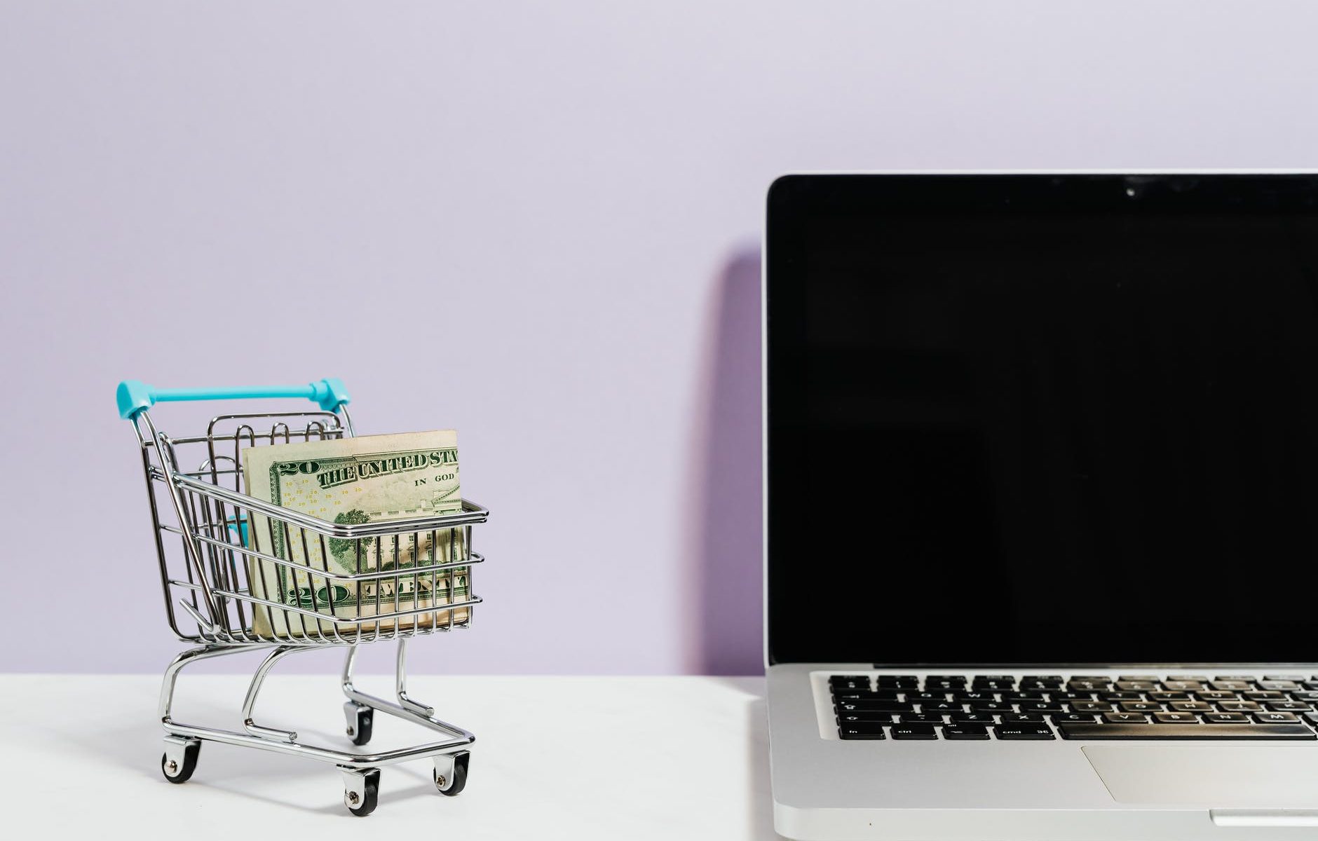 shopping cart next to a laptop