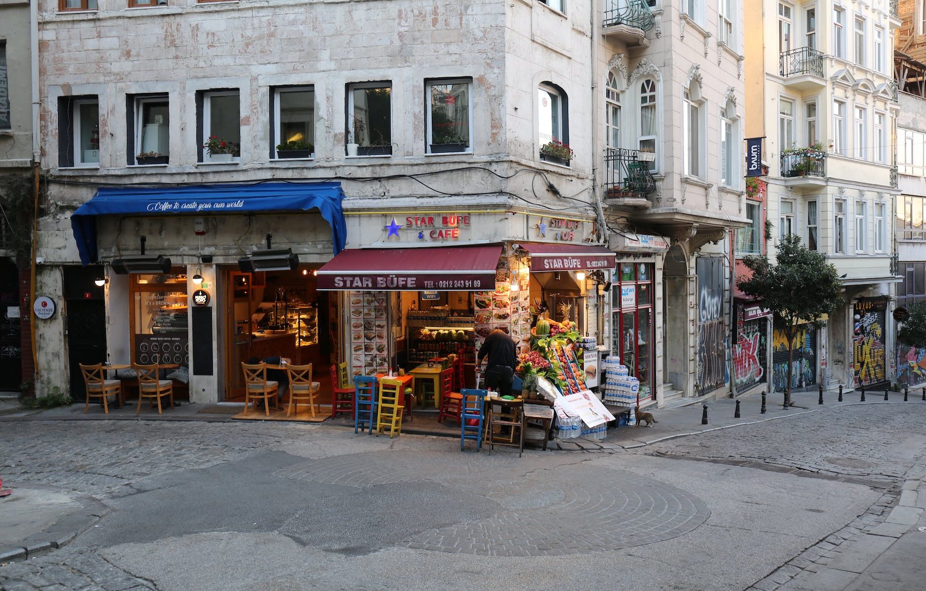 a coffee shop and a store on the corner of the street