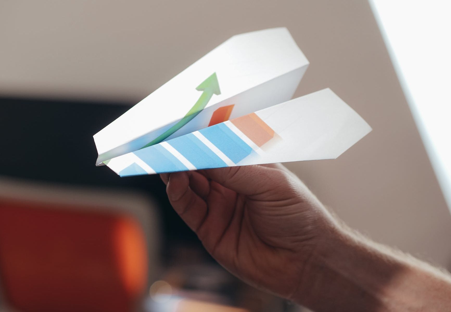 a person holding paper airplane