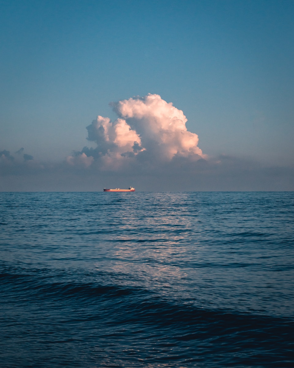 boat under white clouds